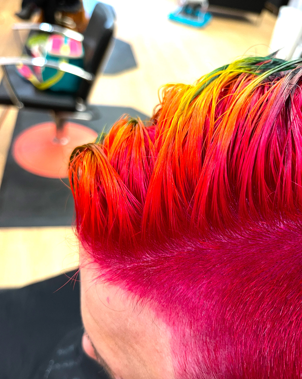 short pink hair with longer rainbow hair on top